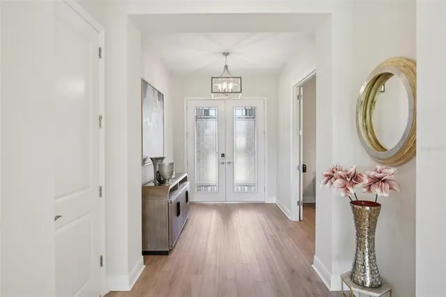 a view of a hallway with wooden floor and entryway