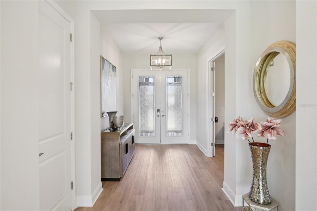 14930 Rider Pass Drive Lithia, FL 33547 - Photo 3 of 63 a view of a hallway with wooden floor and entryway