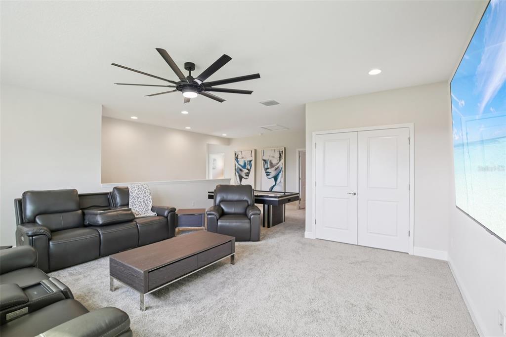 14930 Rider Pass Drive Lithia, FL 33547 - Photo 33 of 63 a living room with furniture and a chandelier