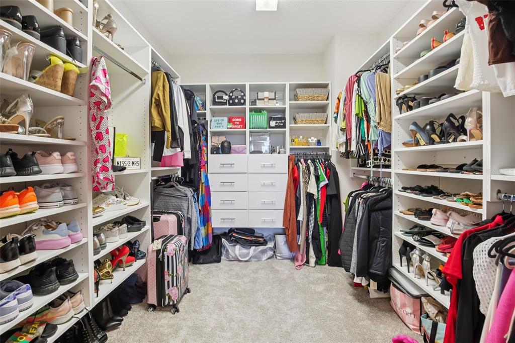 14930 Rider Pass Drive Lithia, FL 33547 - Photo 36 of 63 a view of walk in closet with clothes and shoes