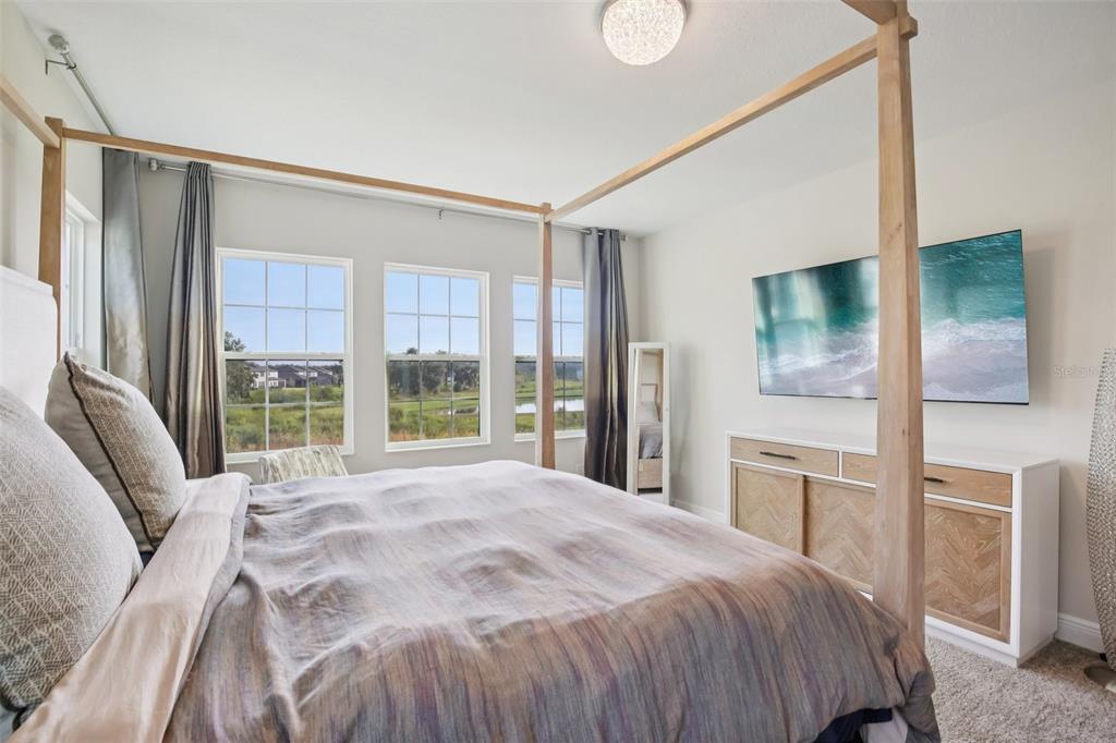 14930 Rider Pass Drive Lithia, FL 33547 - Photo 41 of 63 a bedroom with a large bed and a large window