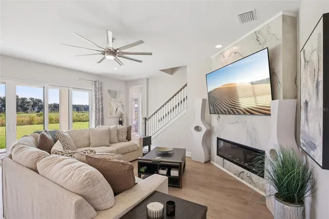 a living room with furniture fireplace and flat screen tv