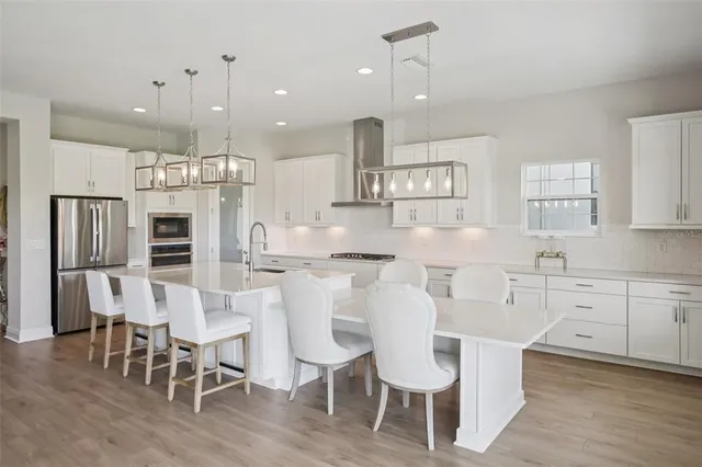 a large kitchen with a table and chairs