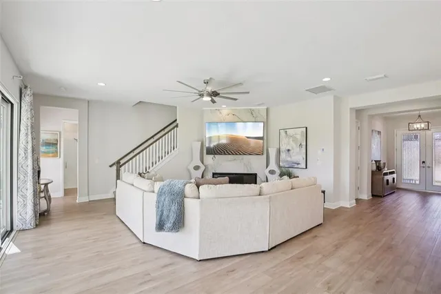 a living room with furniture and a wooden floor