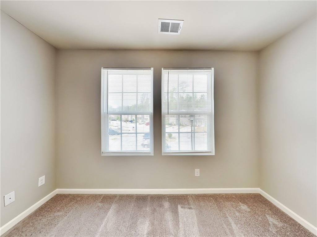 2565 Piering Drive Lithonia, GA 30038 - Photo 17 of 20 an empty room with wooden floor and windows