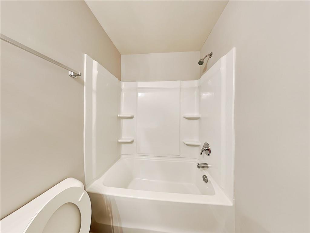 2565 Piering Drive Lithonia, GA 30038 - Photo 18 of 20 a bath room with a toilet and a bath tub