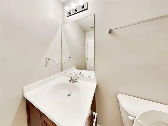a bathroom with a sink vanity and a mirror