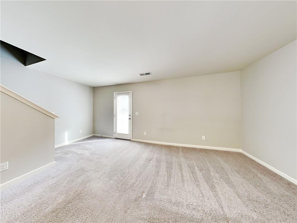 2565 Piering Drive Lithonia, GA 30038 - Photo 4 of 20 a view of an empty room with wooden floor and a window