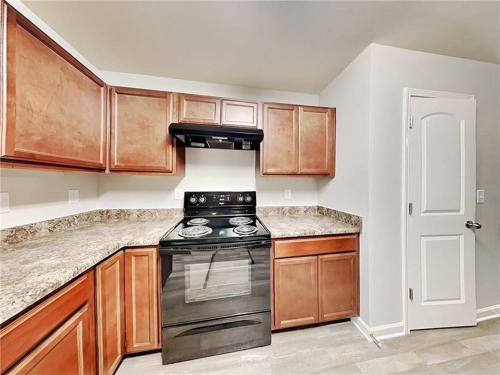 2565 Piering Drive Lithonia, GA 30038 - Photo 8 of 20 a kitchen with a stove and a microwave