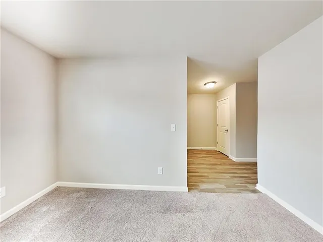 a view of an empty room and wooden door
