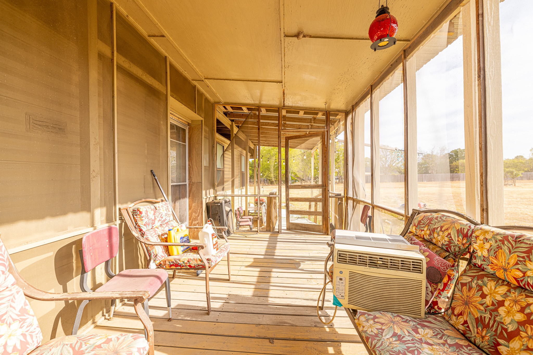 1313 Greenbriar Road Madisonville, TX 77864 - Photo 11 of 25 a living room with furniture and floor to ceiling windows