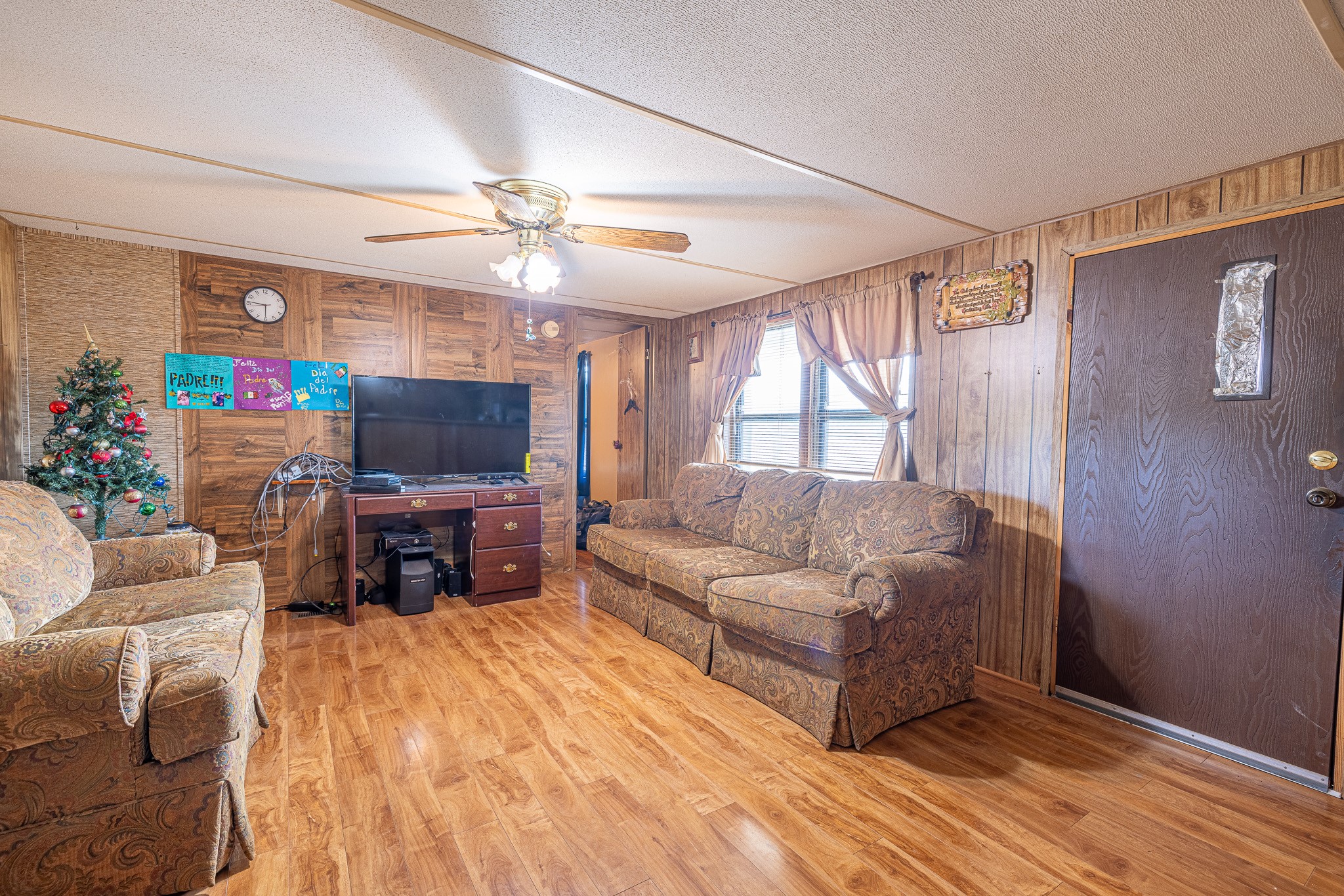 1313 Greenbriar Road Madisonville, TX 77864 - Photo 14 of 25 a living room with furniture a fireplace and a flat screen tv
