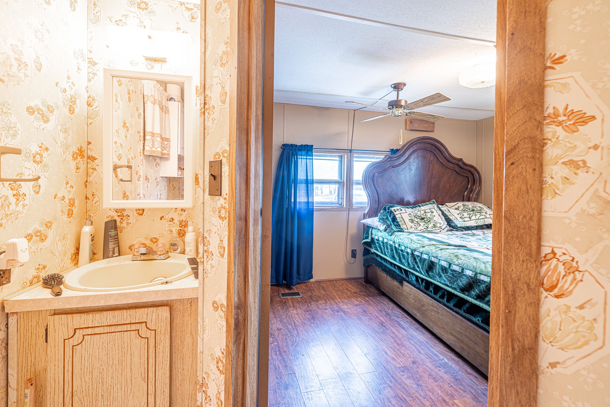 1313 Greenbriar Road Madisonville, TX 77864 - Photo 16 of 25 a bedroom with a bed and a wooden floor