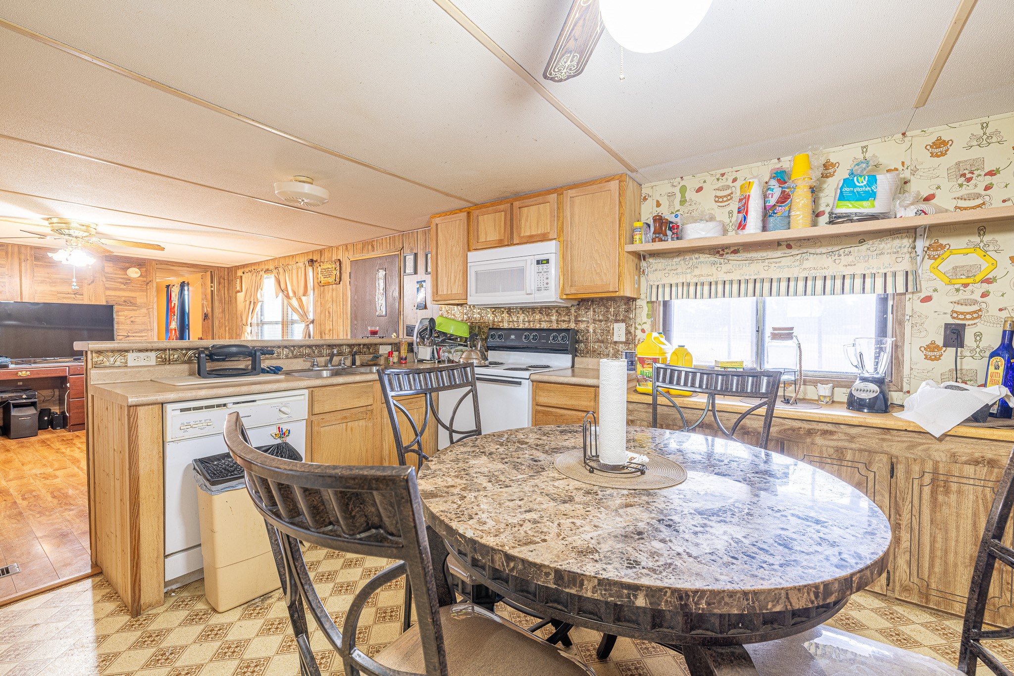 1313 Greenbriar Road Madisonville, TX 77864 - Photo 18 of 25 a dining room with furniture and a kitchen view