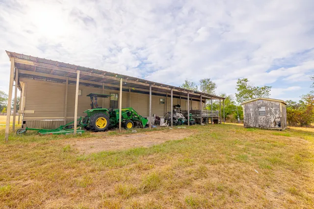 a view of a house with a yard and table and chairs