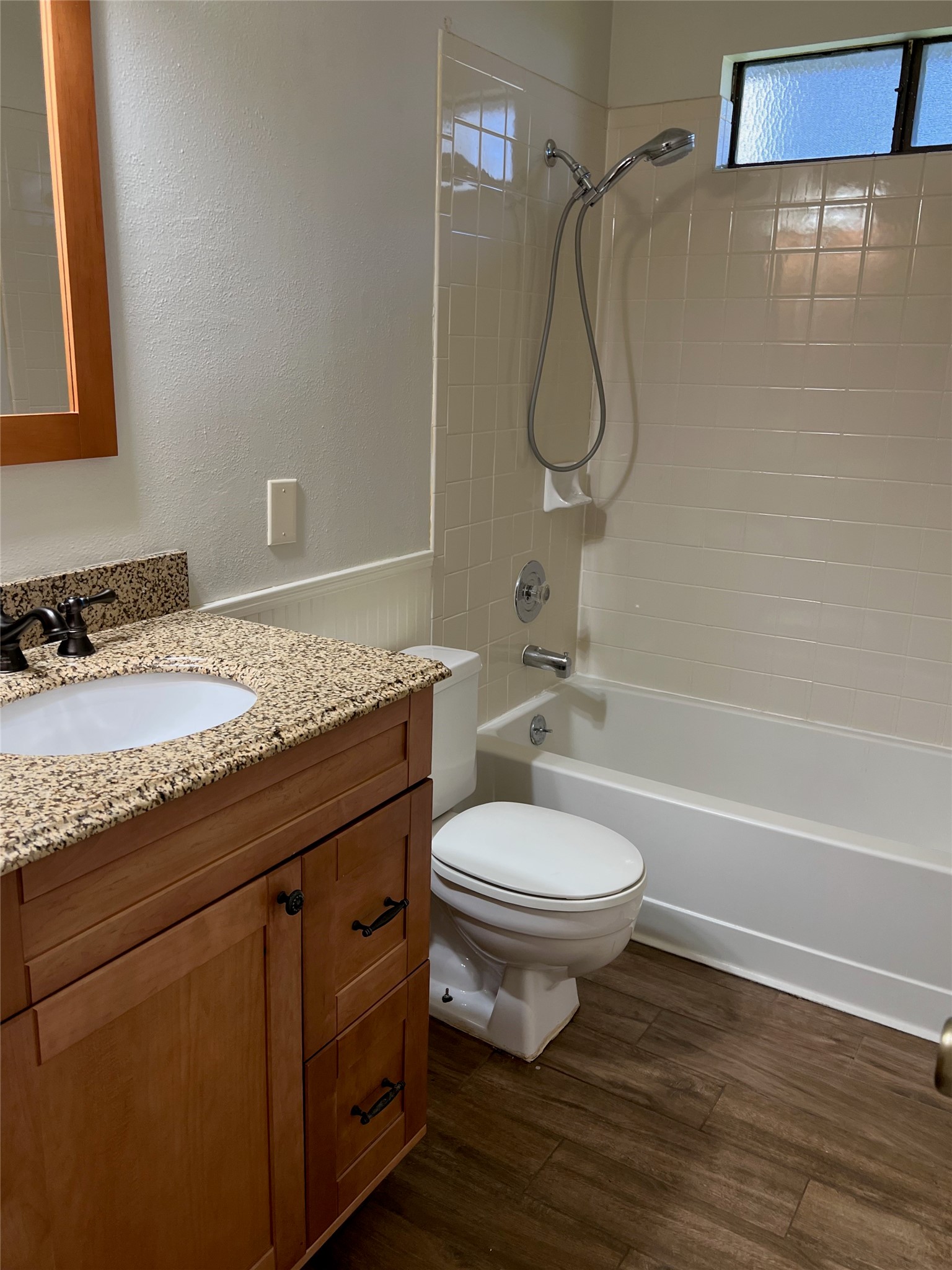 7010 Dallas Drive Austin, TX 78729 - Photo 11 of 14 a bathroom with a granite countertop toilet a sink and bathtub