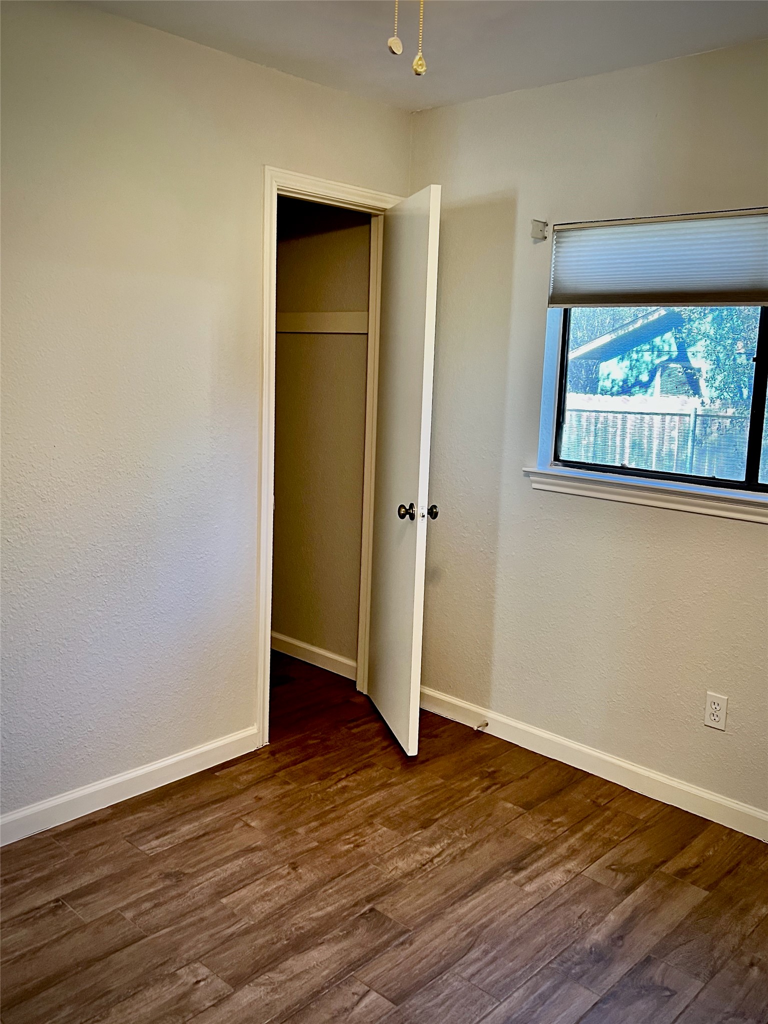 7010 Dallas Drive Austin, TX 78729 - Photo 12 of 14 an empty room with wooden floor and closet