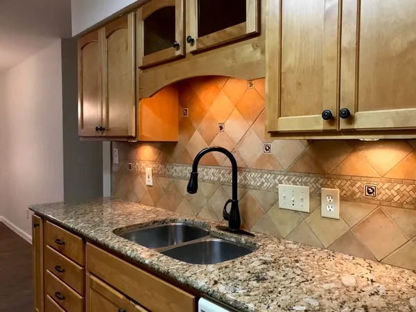 a kitchen with a sink and a stove top oven