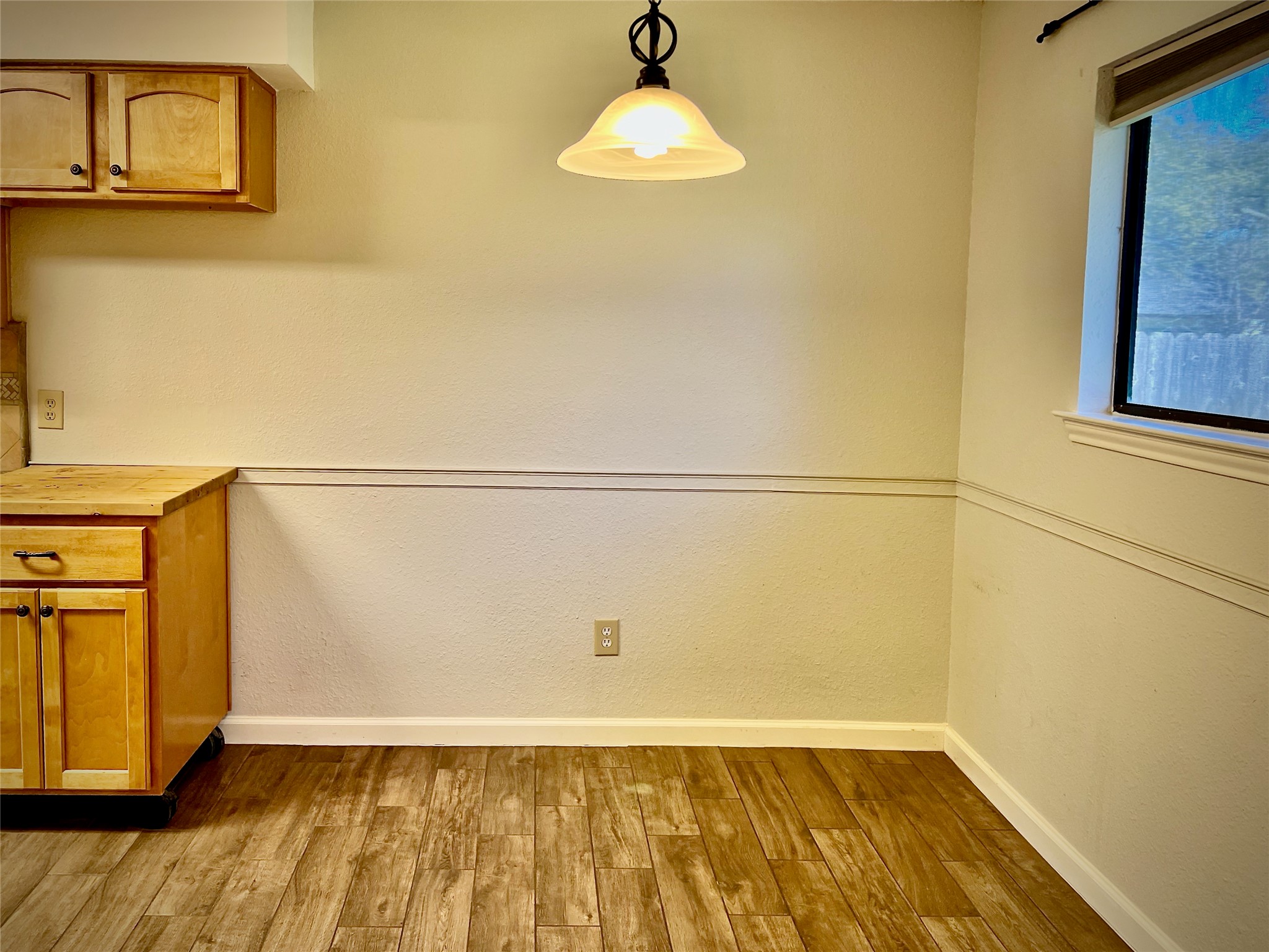 7010 Dallas Drive Austin, TX 78729 - Photo 6 of 14 a view of an empty room with wooden floor and a window