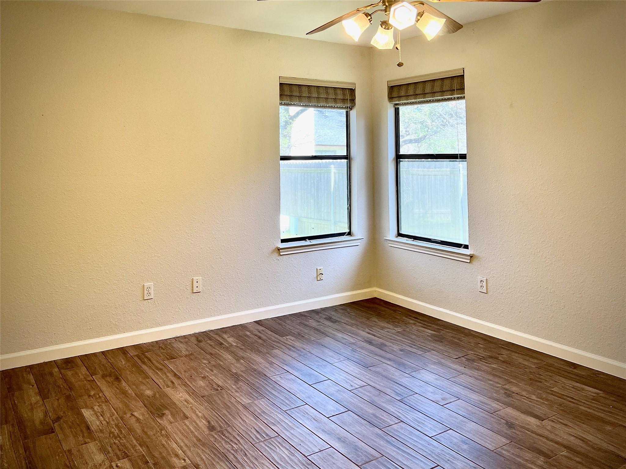 7010 Dallas Drive Austin, TX 78729 - Photo 7 of 14 an empty room with wooden floor and windows