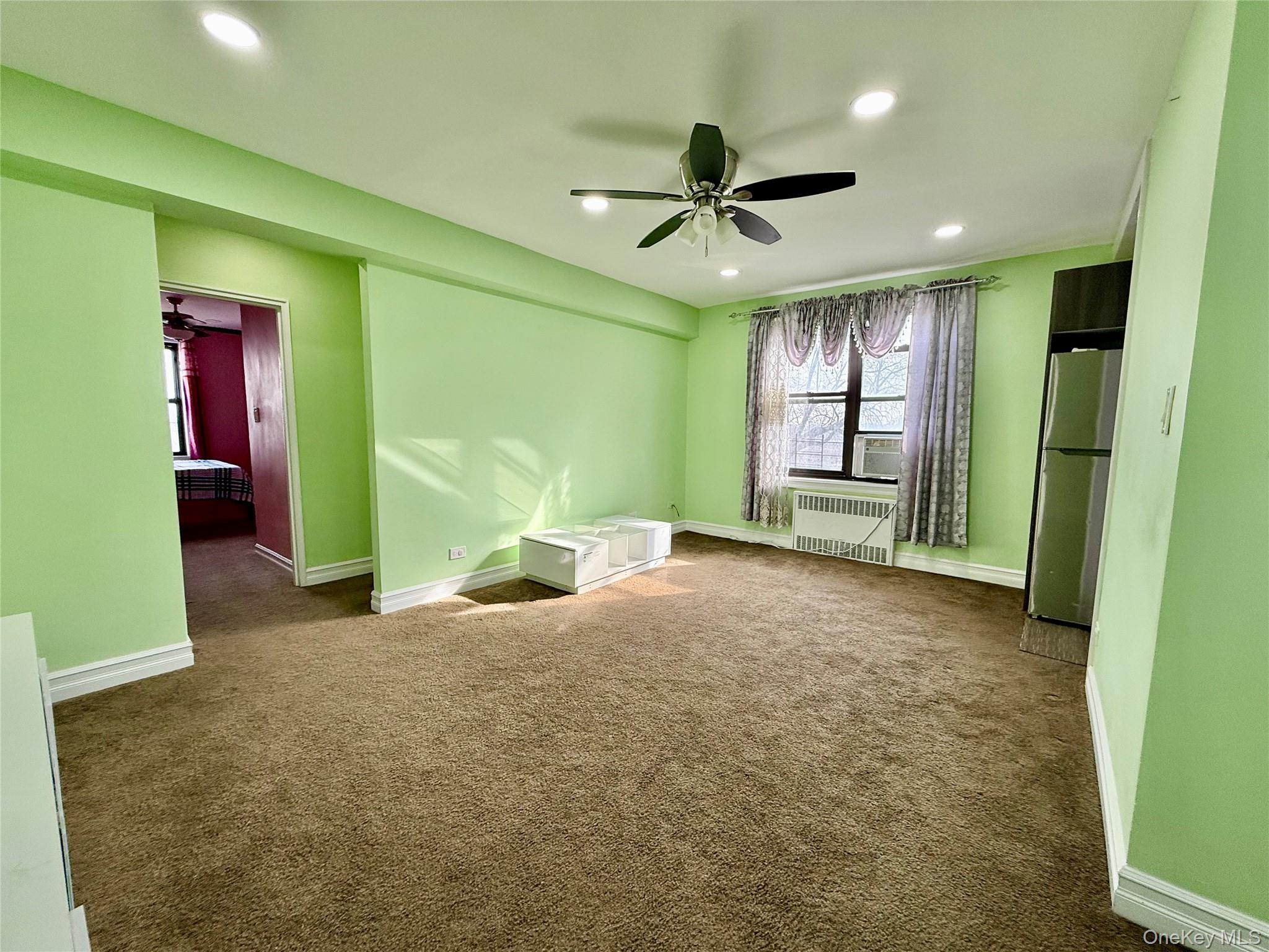 112-30 Northern Boulevard, Unit 4G Queens, NY 11368 - Photo 11 of 38 an empty room with closet and windows