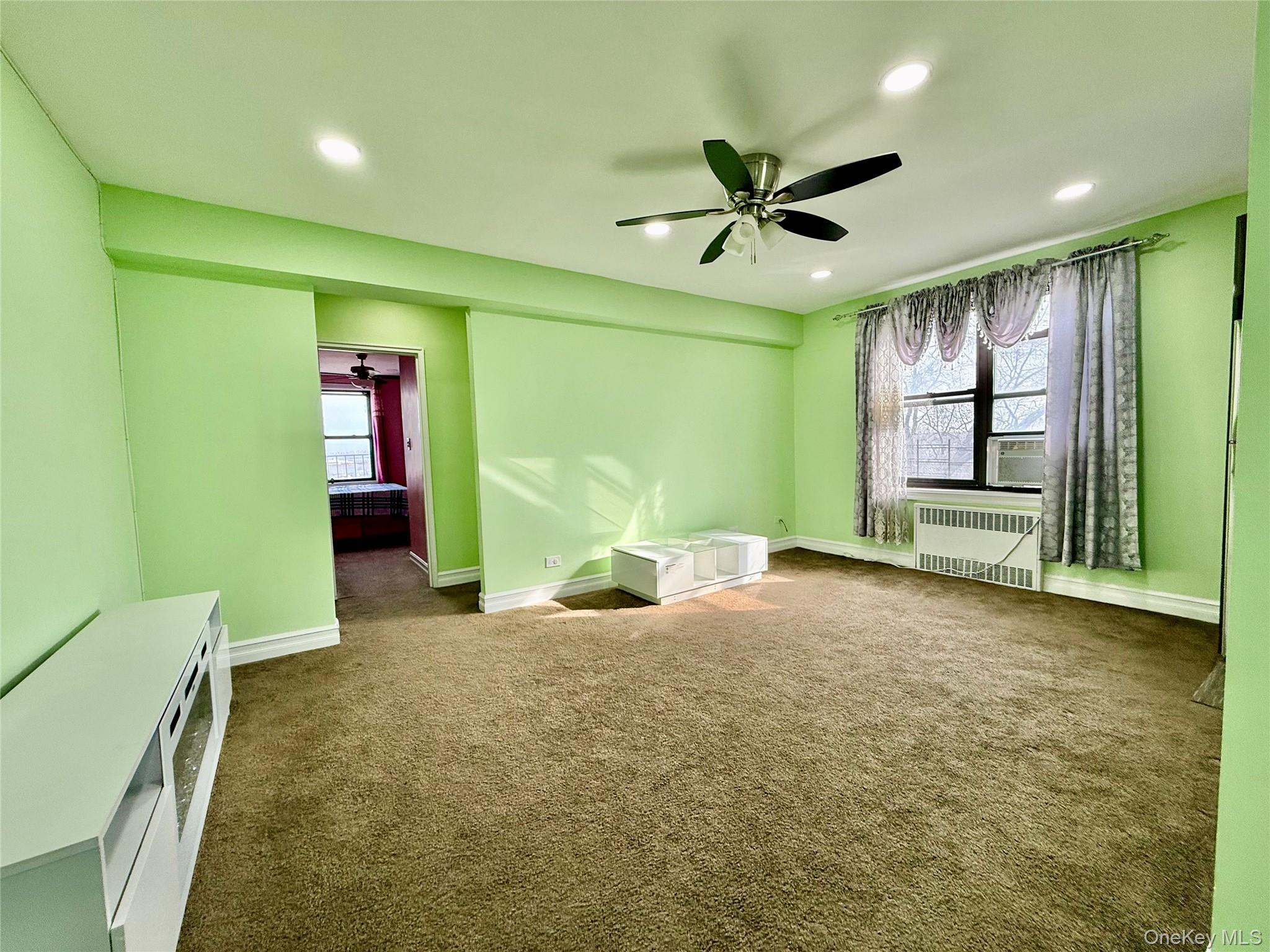 112-30 Northern Boulevard, Unit 4G Queens, NY 11368 - Photo 13 of 38 a view of a livingroom with a ceiling fan and window