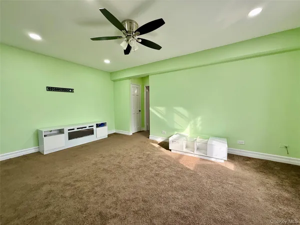 a view of a livingroom with a ceiling fan and a projector