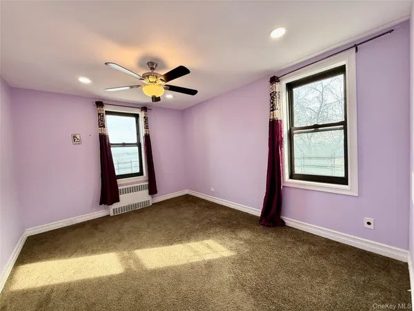 a view of a livingroom with a window and a ceiling fan