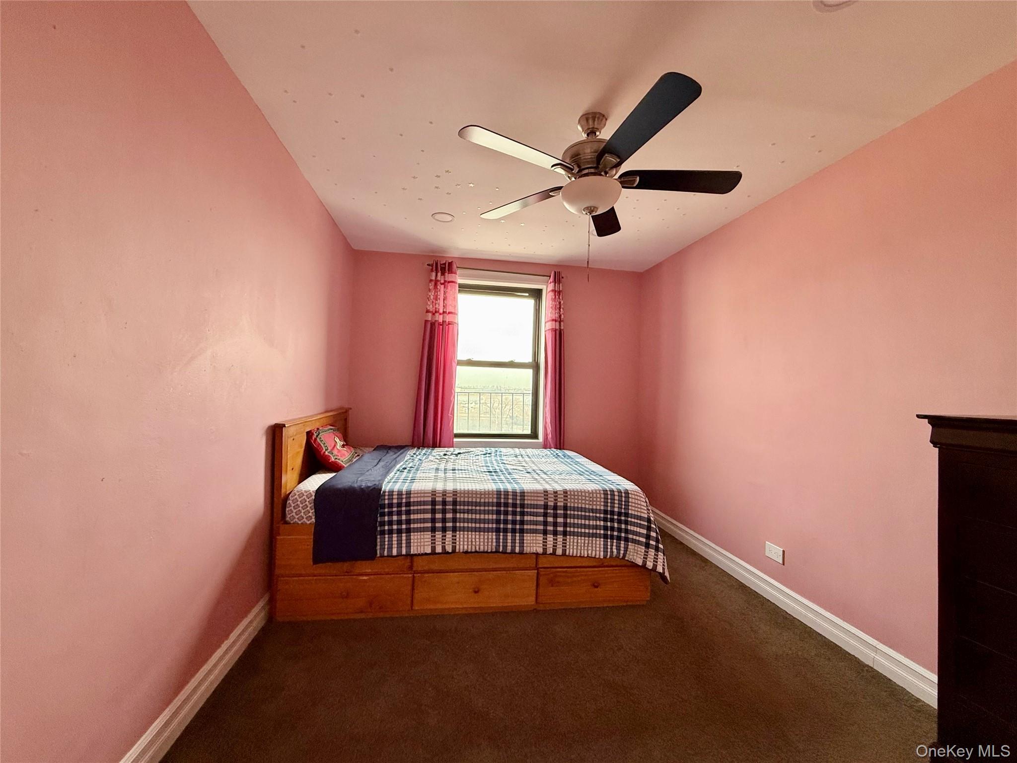 112-30 Northern Boulevard, Unit 4G Queens, NY 11368 - Photo 19 of 38 a bedroom with a bed and window