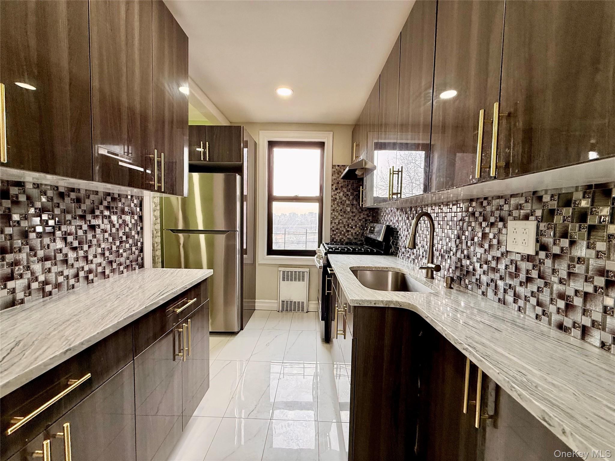 112-30 Northern Boulevard, Unit 4G Queens, NY 11368 - Photo 2 of 38 a kitchen with a sink stove and refrigerator