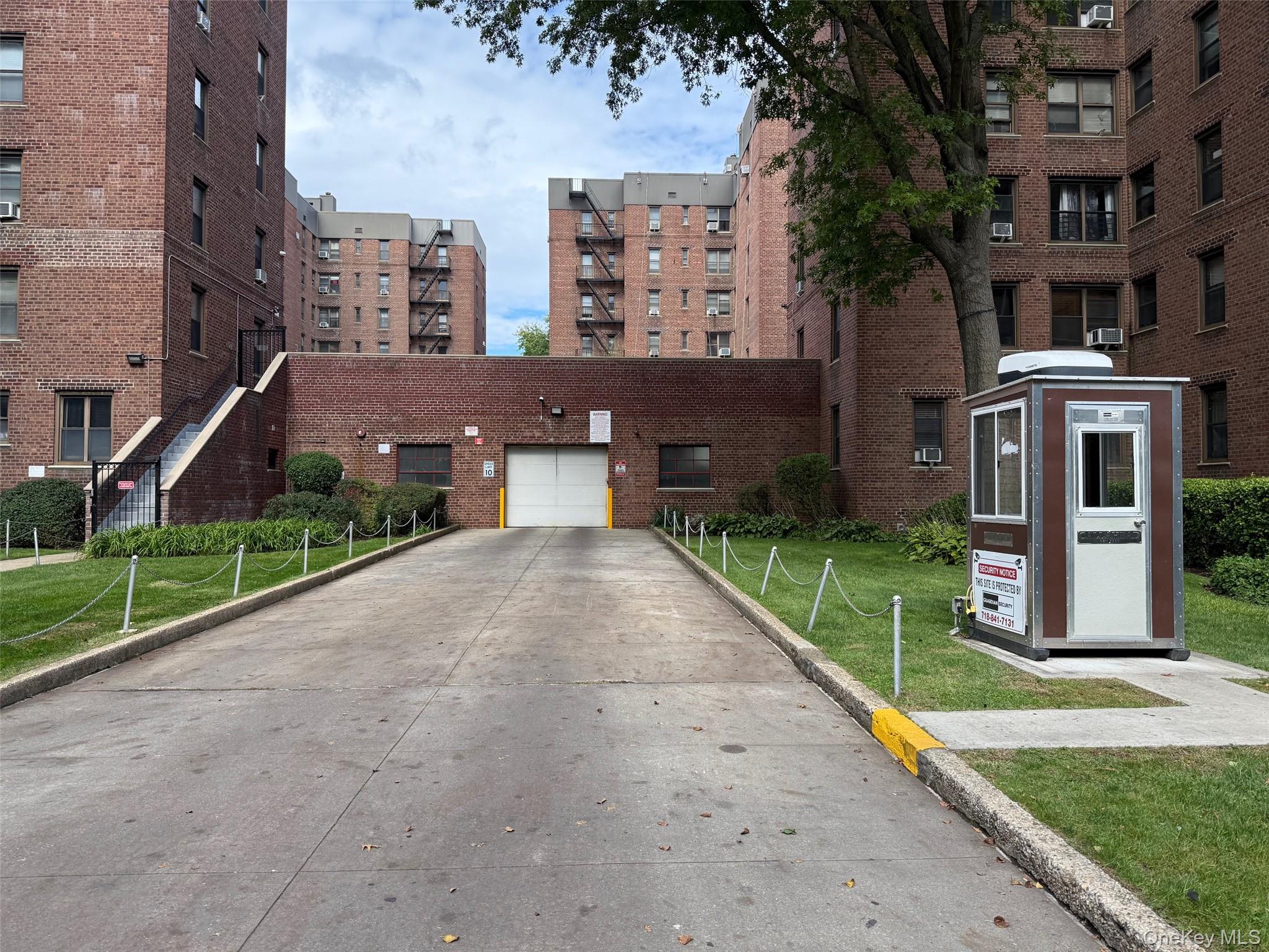112-30 Northern Boulevard, Unit 4G Queens, NY 11368 - Photo 29 of 38 a front view of a residential apartment building with a yard
