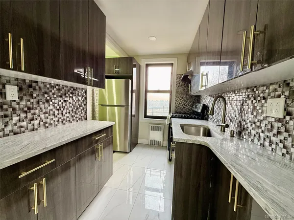 a kitchen with a sink stove and refrigerator