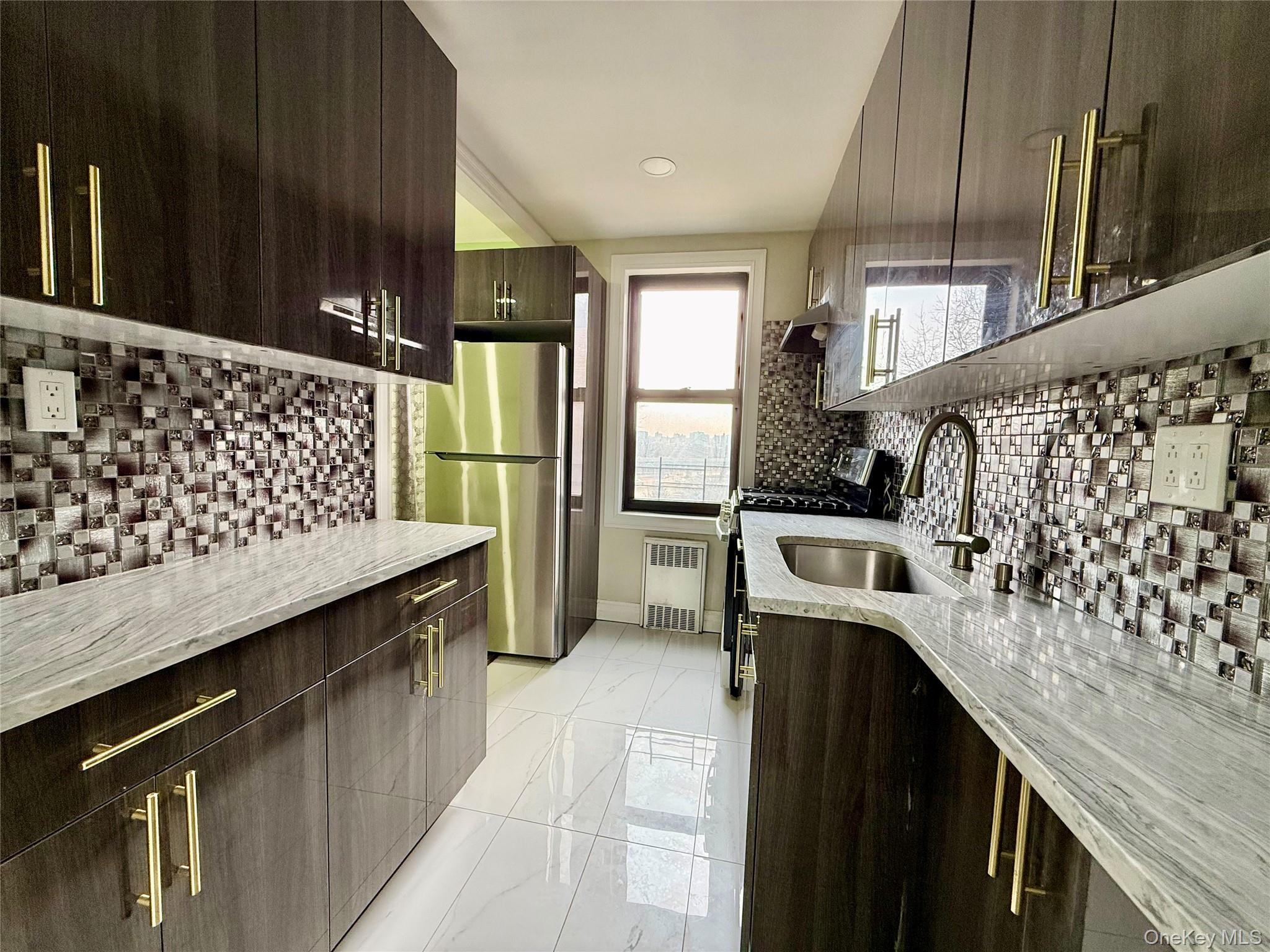 112-30 Northern Boulevard, Unit 4G Queens, NY 11368 - Photo 5 of 38 a kitchen with a sink stove and refrigerator