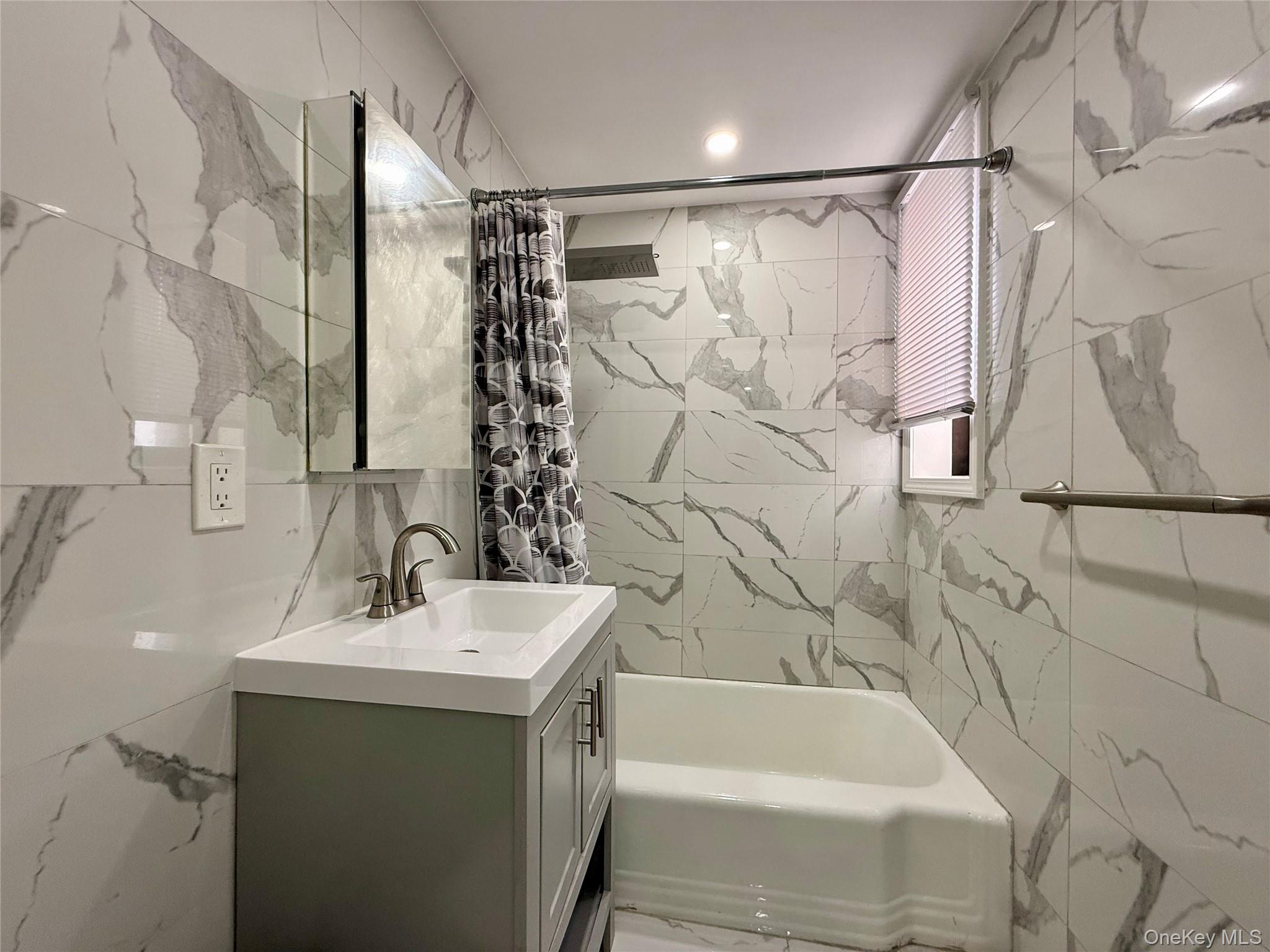 112-30 Northern Boulevard, Unit 4G Queens, NY 11368 - Photo 7 of 38 a bathroom with a sink and a bathtub