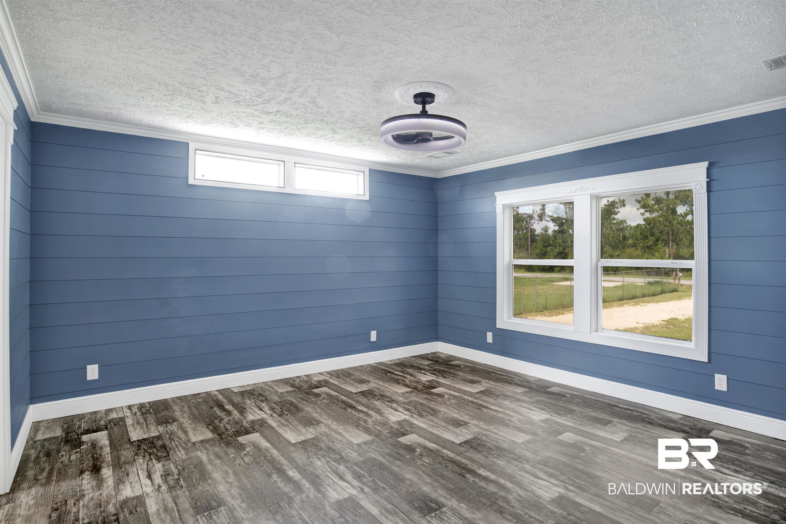 16778 County Road 87 Elberta, AL 36530 - Photo 20 of 32 Spare room with crown molding, hardwood / wood-style floors, and a textured ceiling