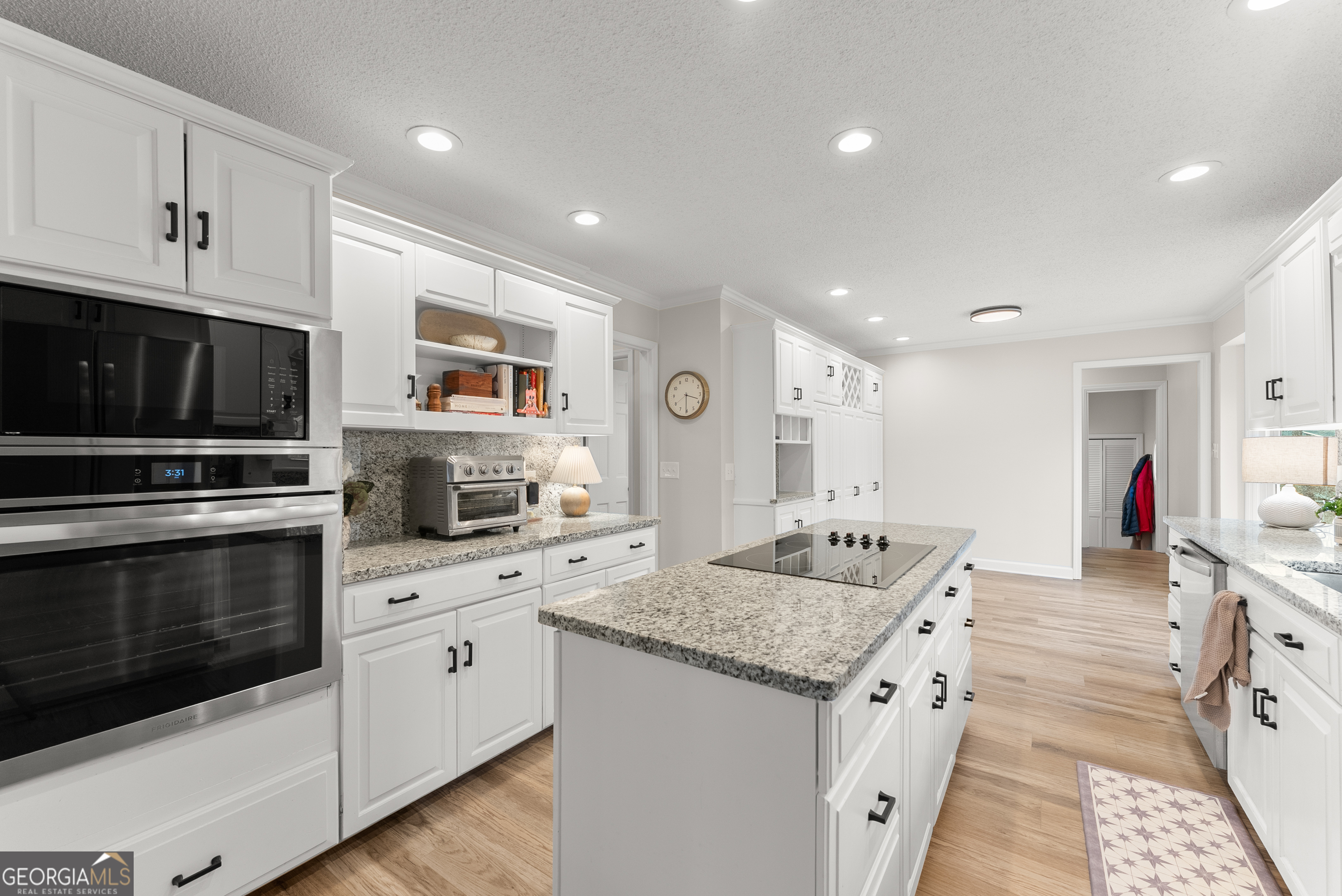 1165 Antioch Campground Road Gainesville, GA 30506 - Photo 18 of 65 a kitchen with granite countertop kitchen island stainless steel appliances a stove sink microwave and cabinets