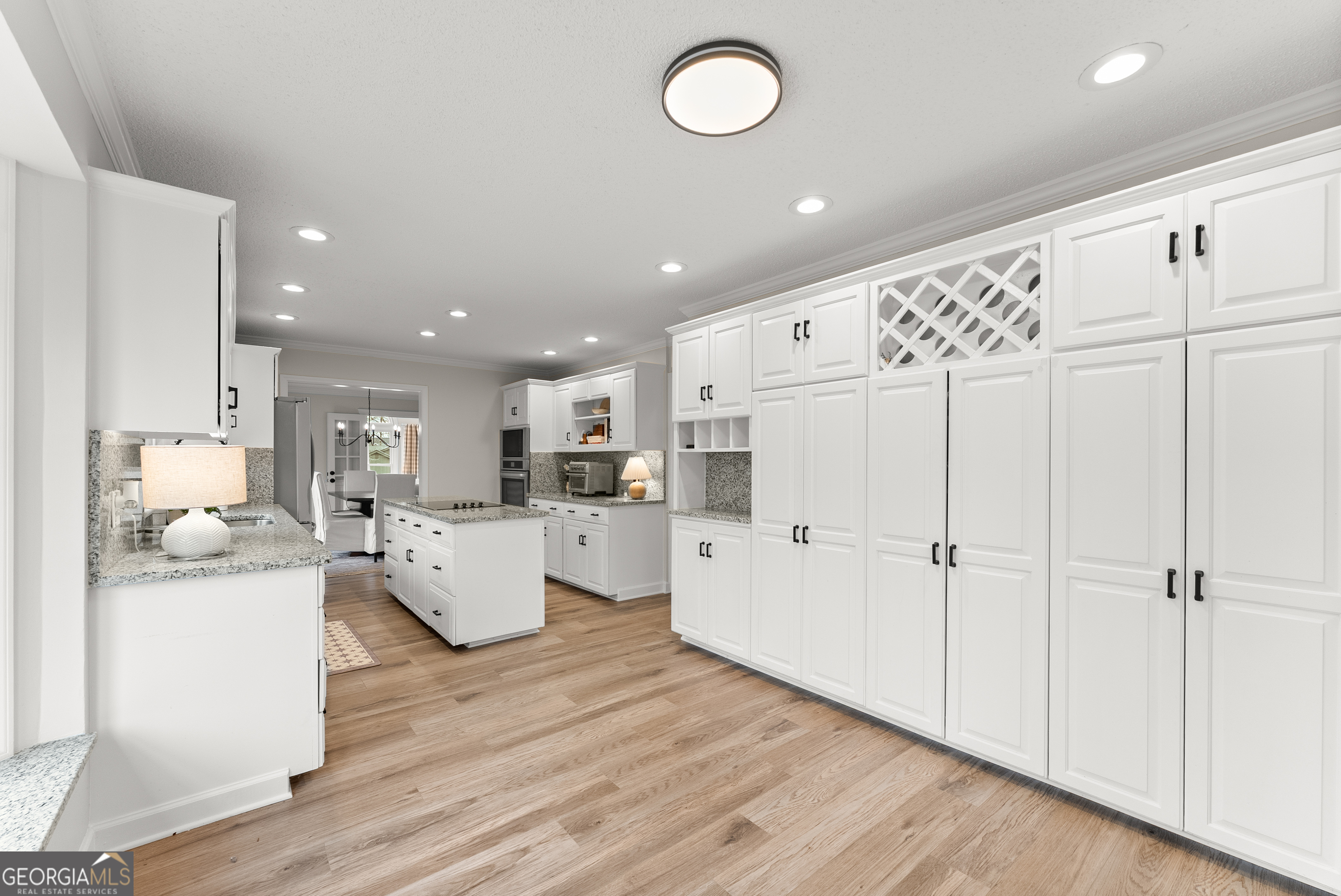 1165 Antioch Campground Road Gainesville, GA 30506 - Photo 23 of 65 a large white kitchen with white cabinets and wooden floor