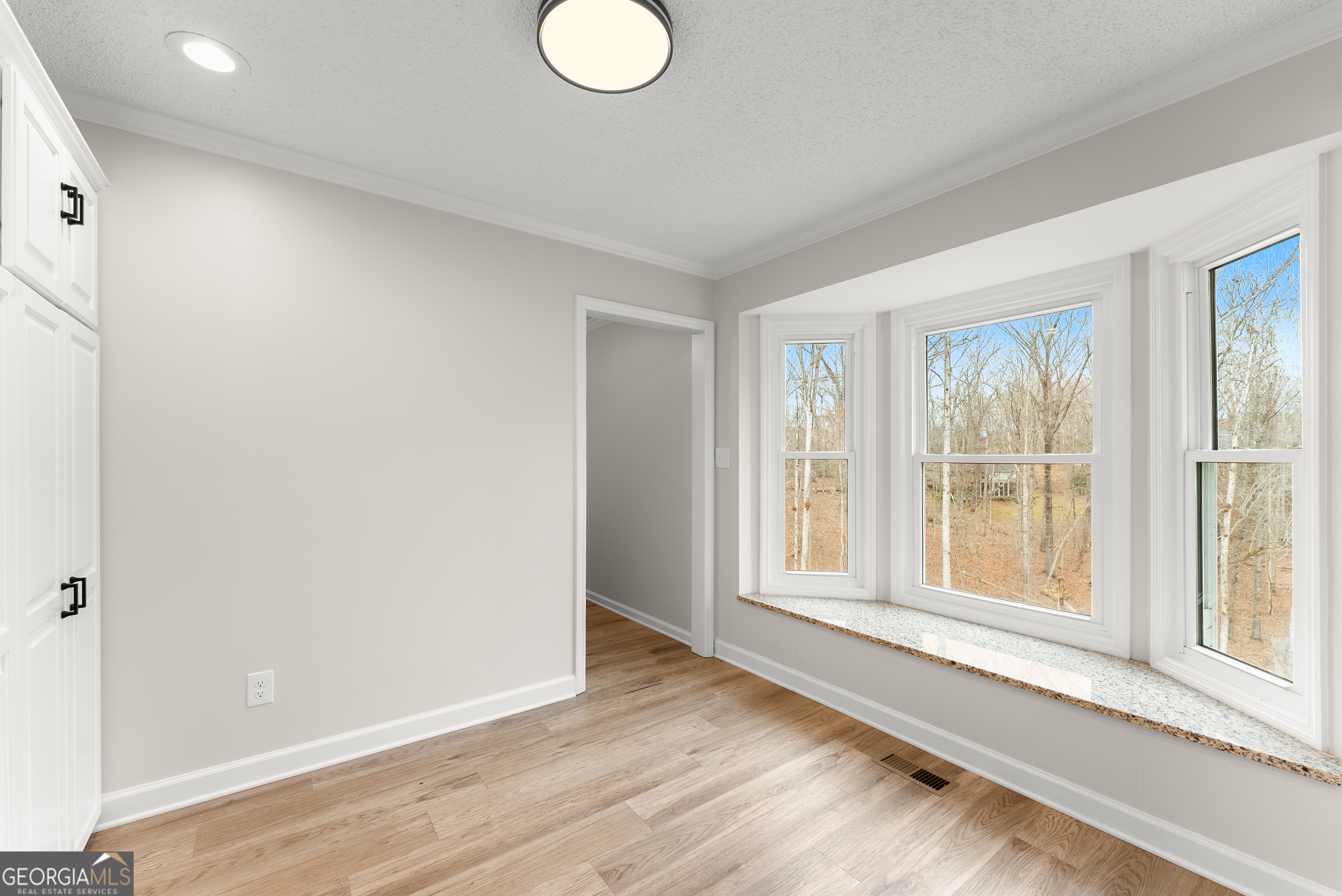 1165 Antioch Campground Road Gainesville, GA 30506 - Photo 24 of 65 a view of an empty room with wooden floor and a window