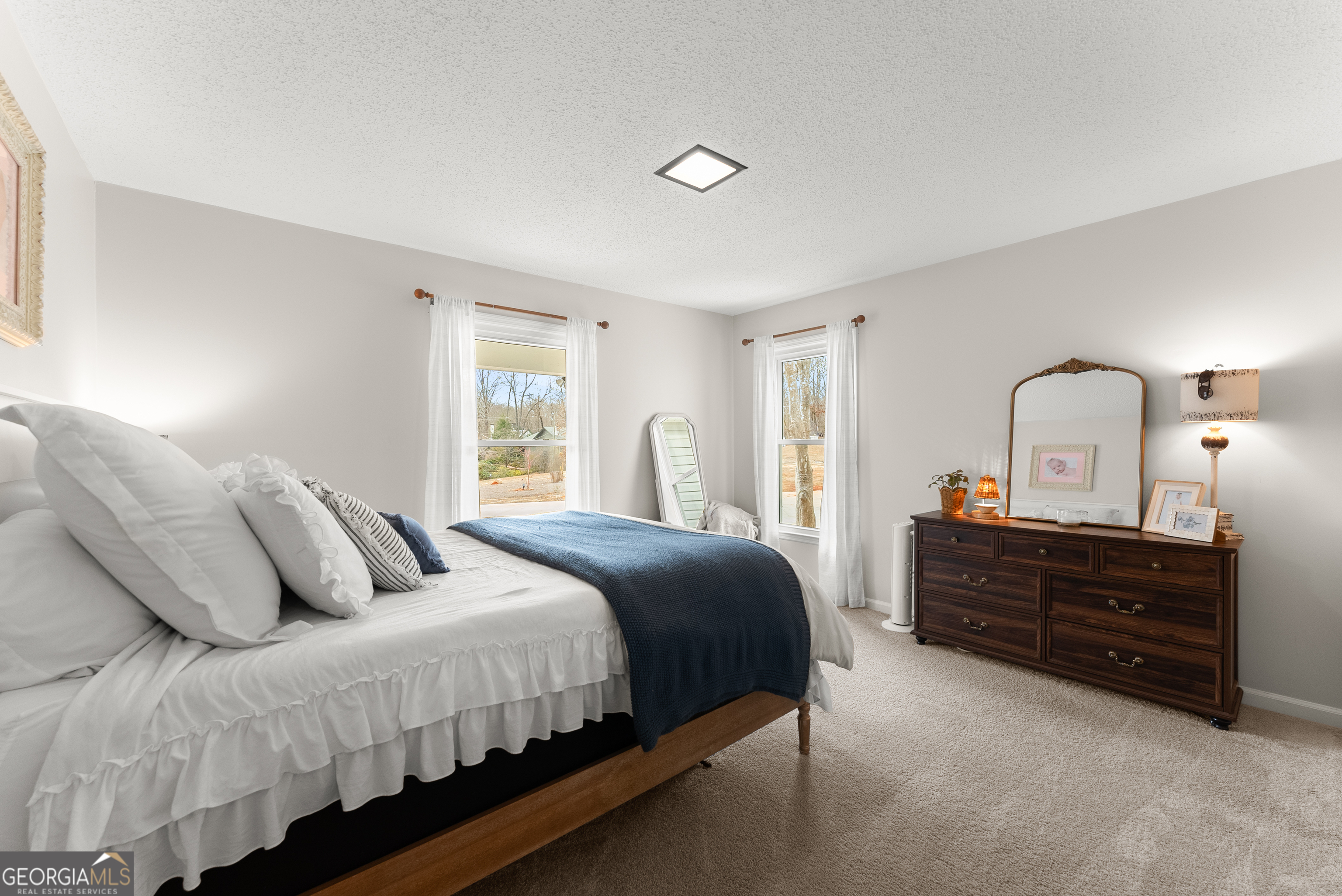 1165 Antioch Campground Road Gainesville, GA 30506 - Photo 27 of 65 a bedroom with a bed and a dresser