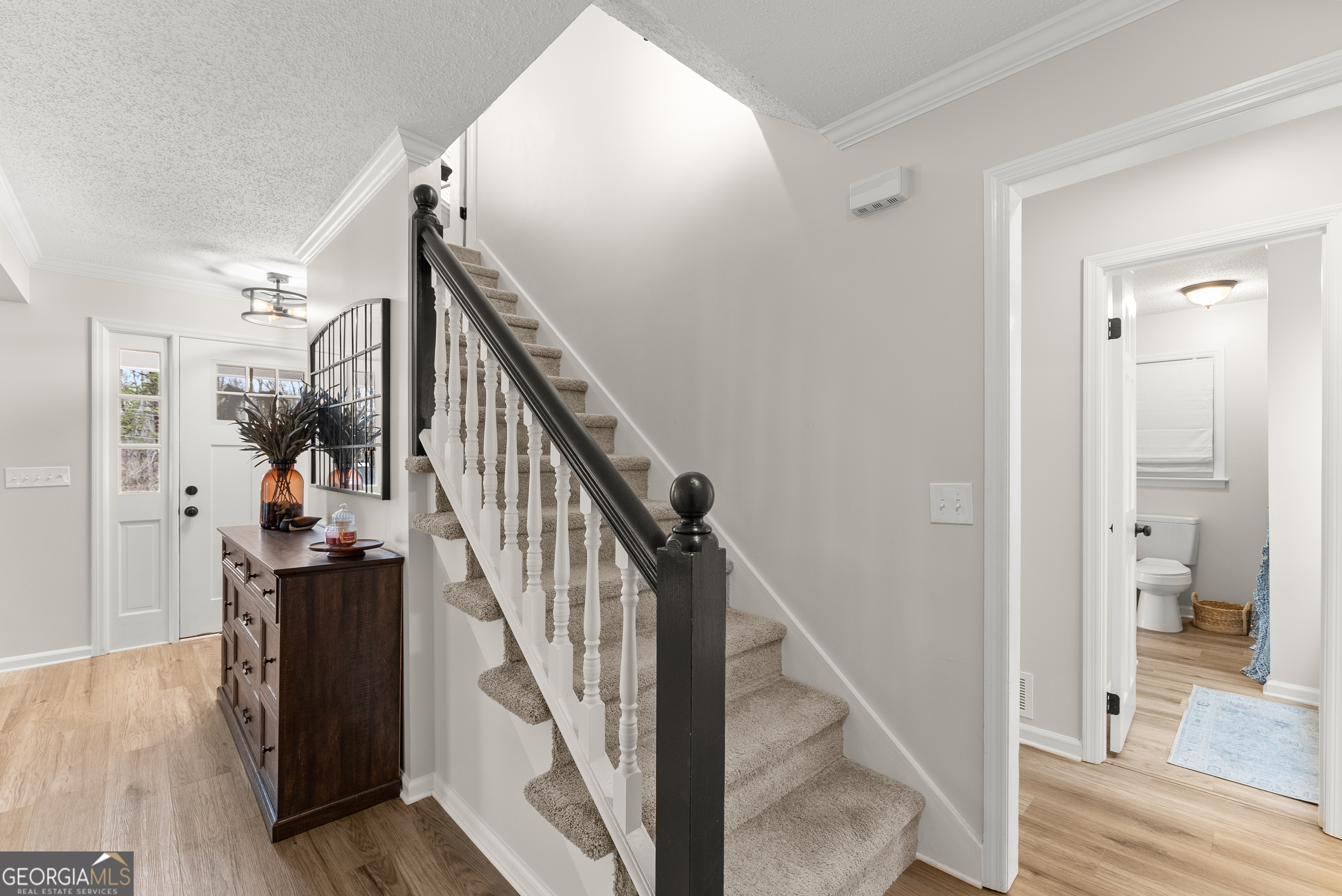 1165 Antioch Campground Road Gainesville, GA 30506 - Photo 31 of 65 a view of a hallway with wooden floor and staircase