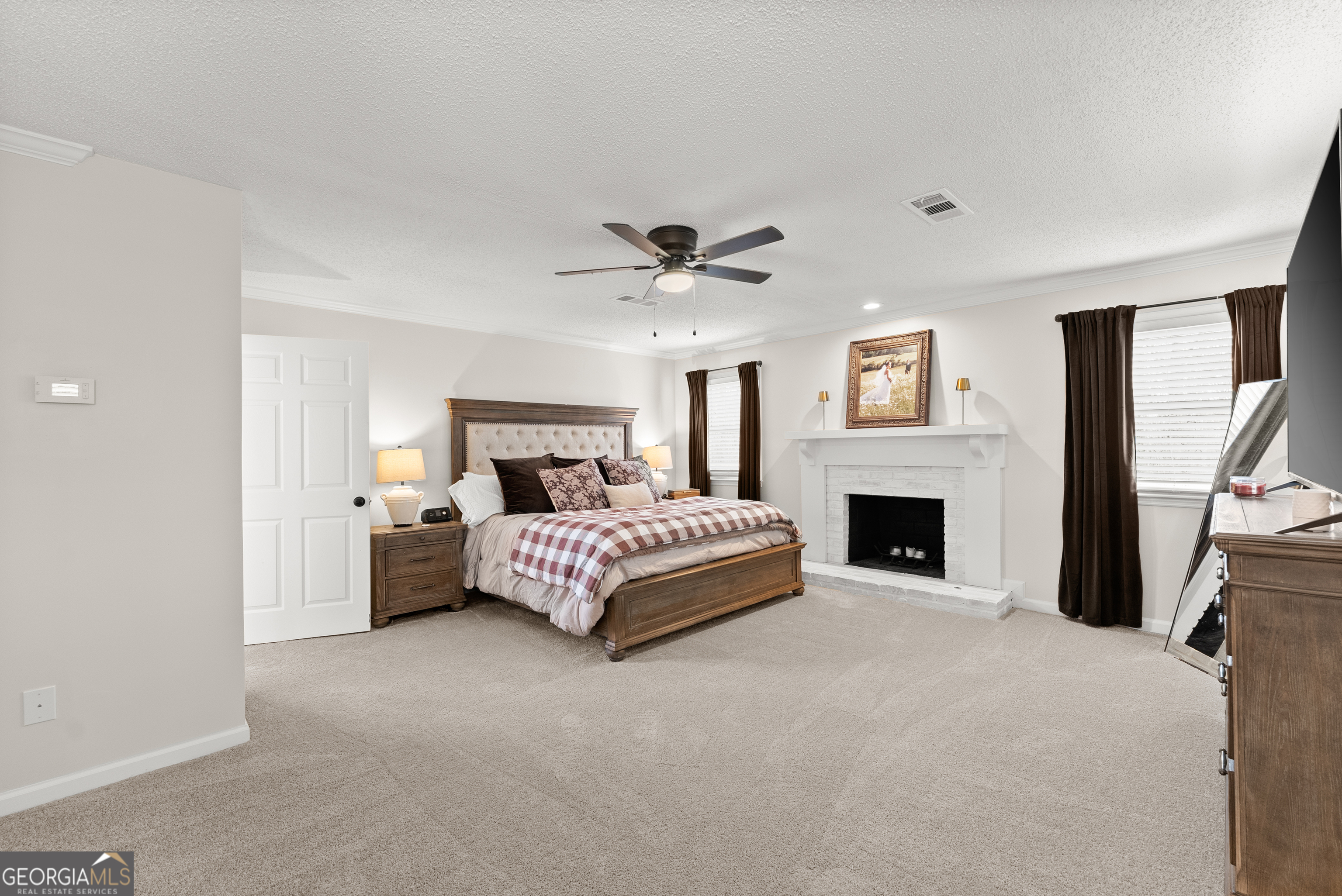 1165 Antioch Campground Road Gainesville, GA 30506 - Photo 32 of 65 a spacious bedroom with a bed and a fireplace