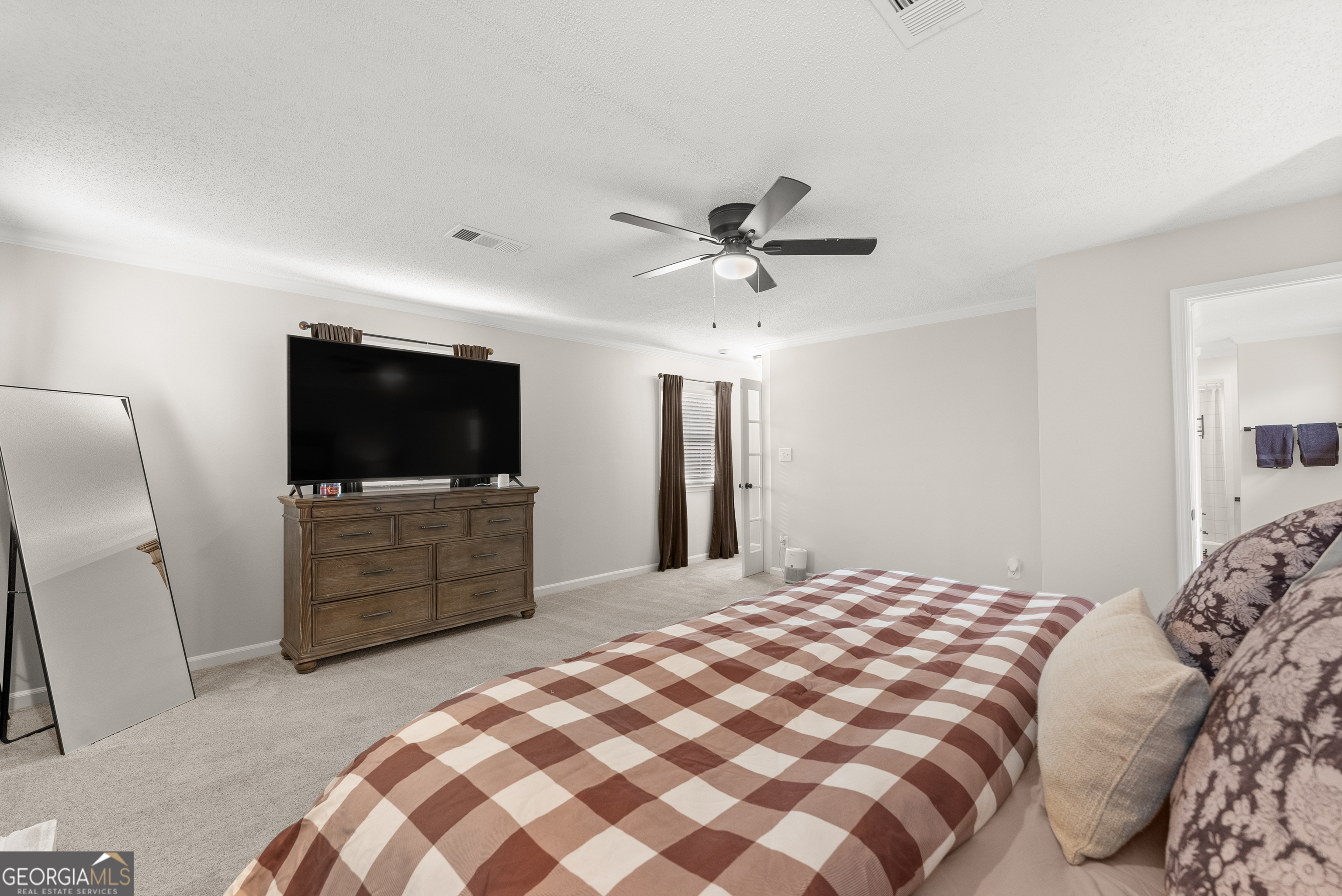 1165 Antioch Campground Road Gainesville, GA 30506 - Photo 34 of 65 a bedroom with a large bed and a flat screen tv