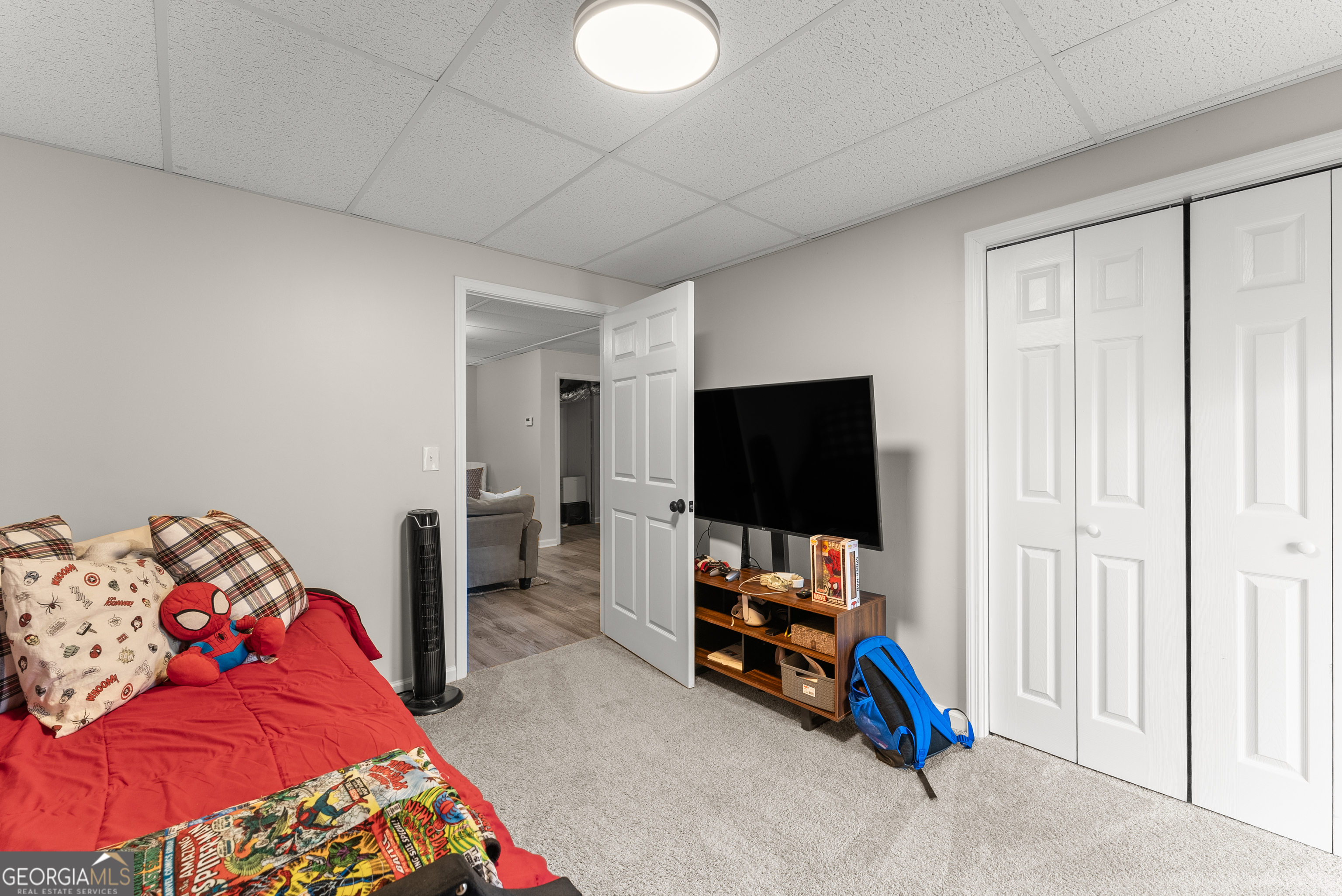 1165 Antioch Campground Road Gainesville, GA 30506 - Photo 49 of 65 a bedroom with bed and a flat tv screen on the dresser