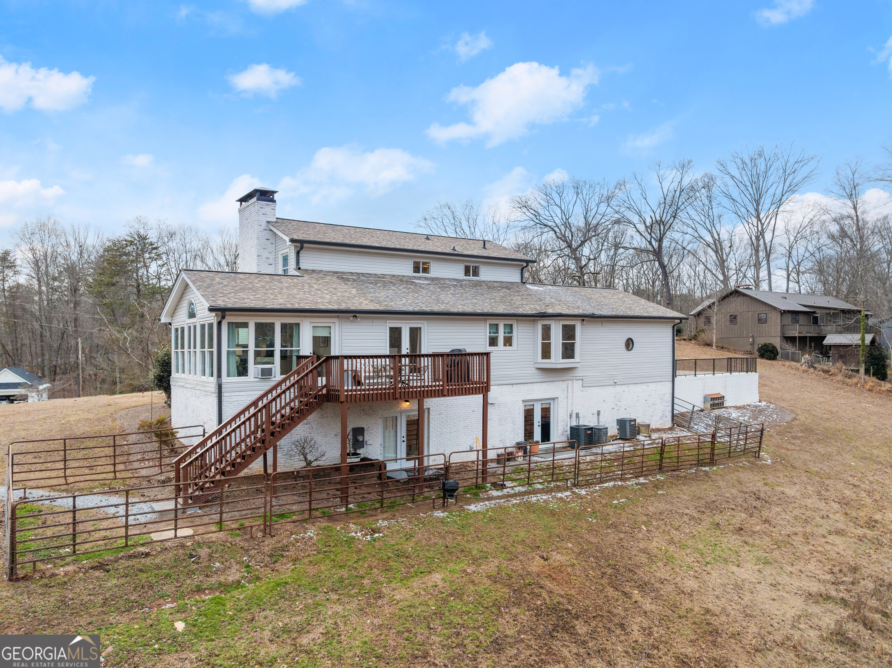1165 Antioch Campground Road Gainesville, GA 30506 - Photo 57 of 65 a view of a big house with wooden fence