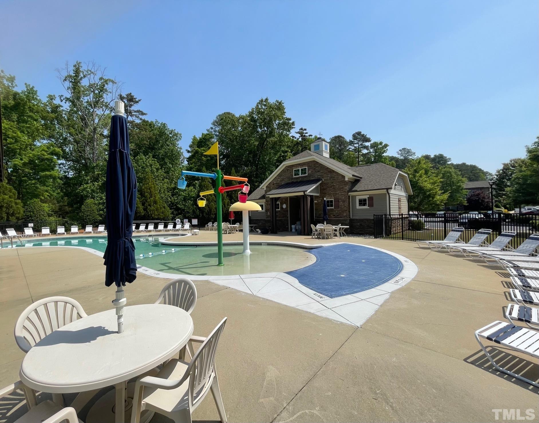 2456 Baslow Drive Apex, NC 27539 - Photo 21 of 39 a swimming pool with some trees in the background