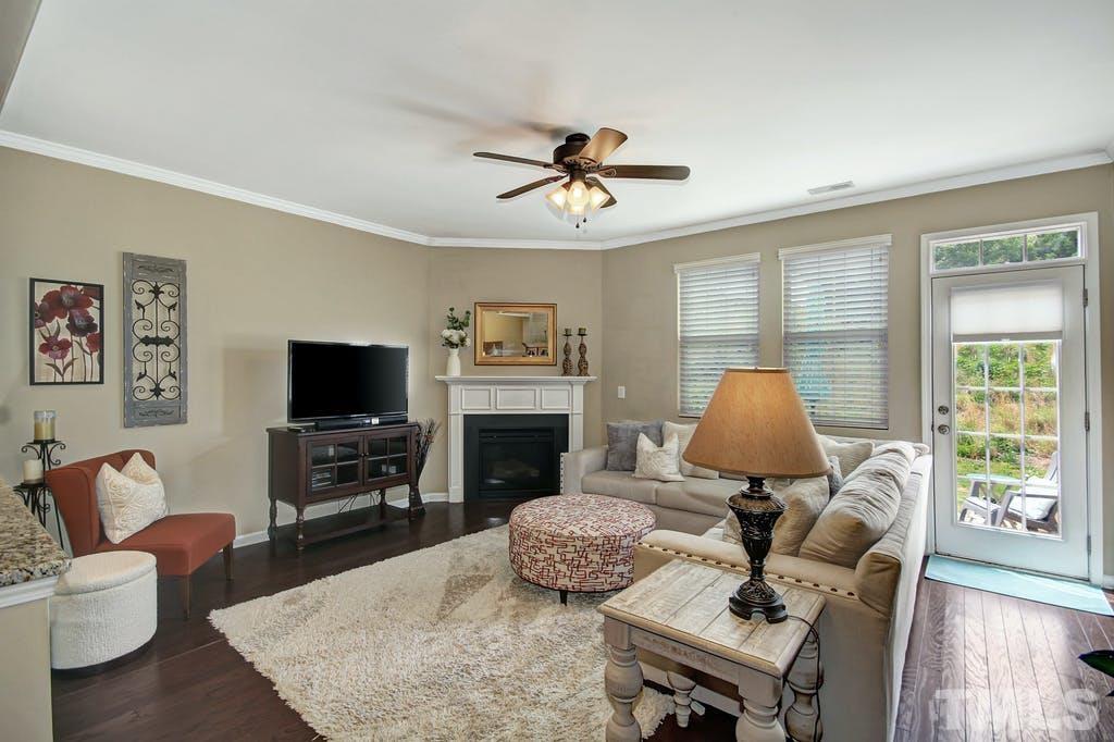 2456 Baslow Drive Apex, NC 27539 - Photo 26 of 39 a living room with furniture fireplace and a flat screen tv