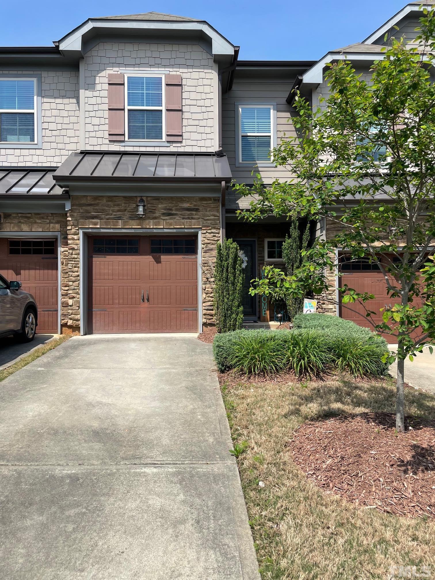 2456 Baslow Drive Apex, NC 27539 - Photo 36 of 39 a front view of a house with a yard and garage