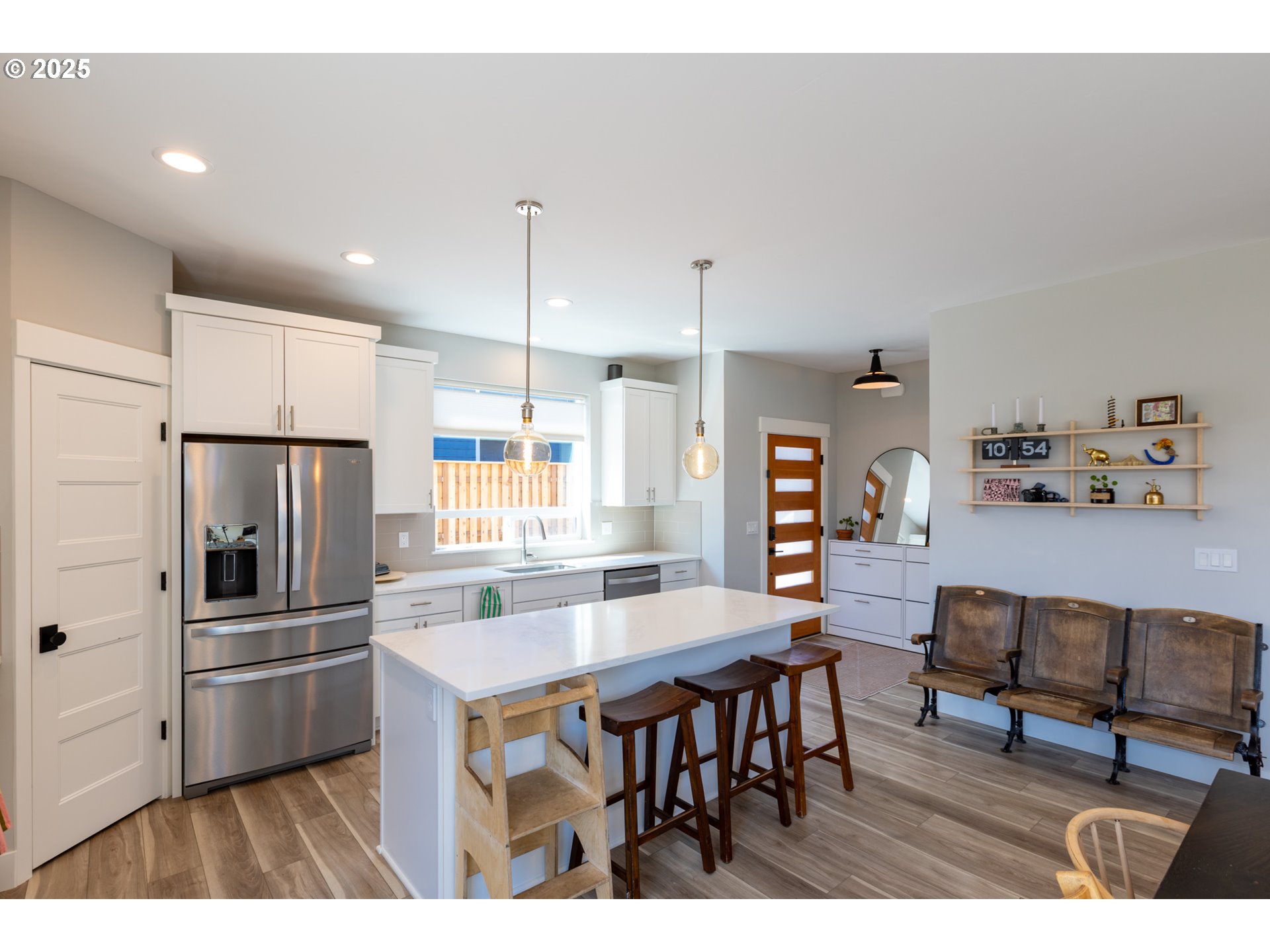 1221 30th Street Hood River, OR 97031 - Photo 21 of 46 a kitchen with stainless steel appliances kitchen island granite countertop a table chairs refrigerator and microwave