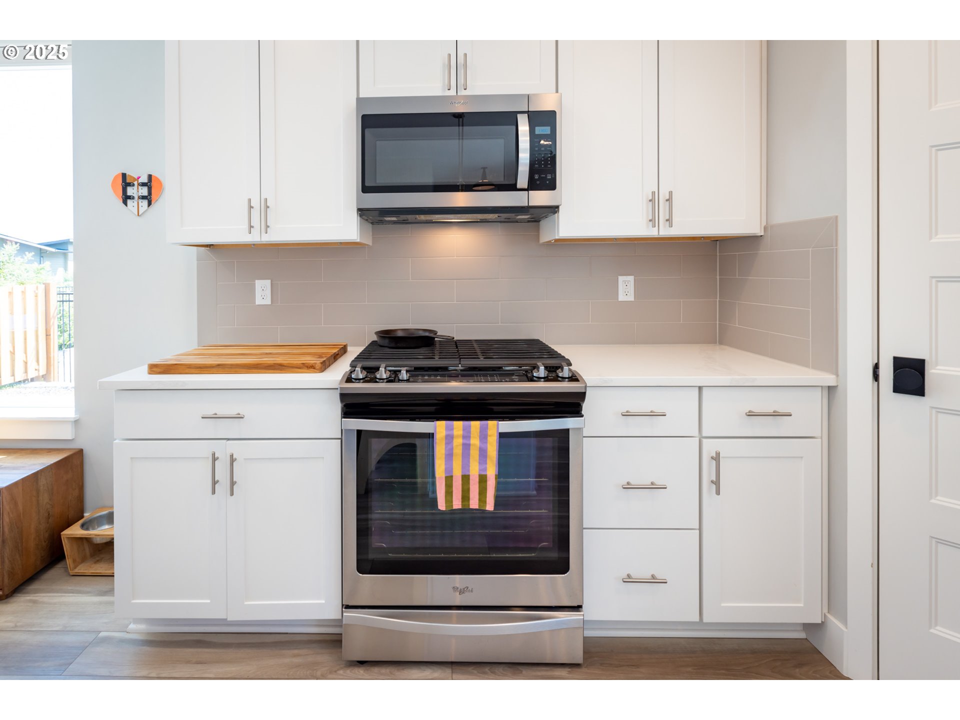 1221 30th Street Hood River, OR 97031 - Photo 22 of 46 a kitchen with stainless steel appliances white cabinets and a stove a sink
