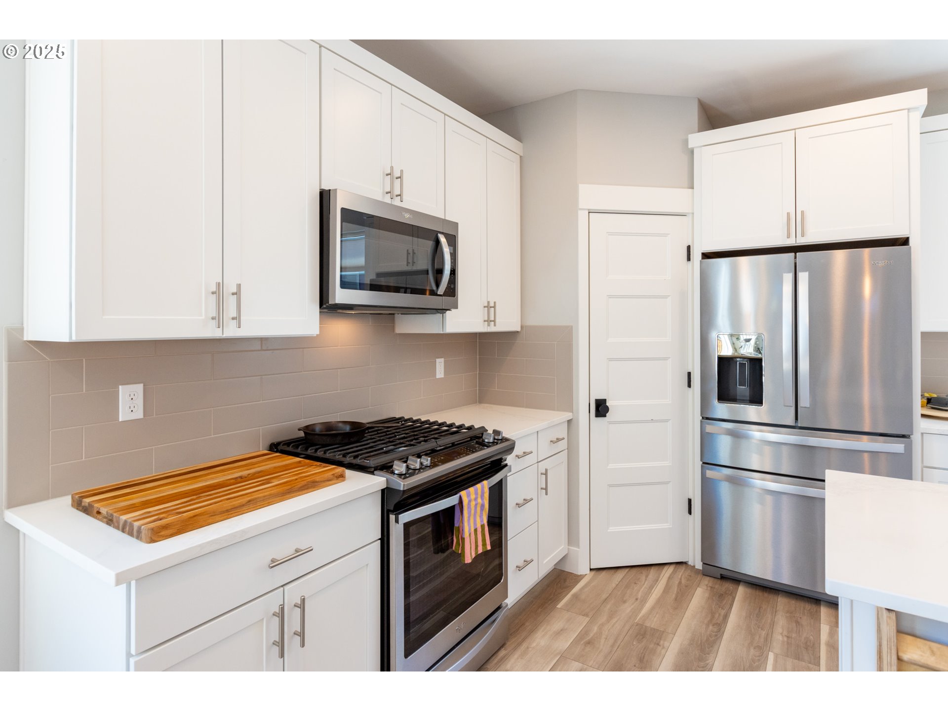 1221 30th Street Hood River, OR 97031 - Photo 23 of 46 a kitchen with stainless steel appliances white cabinets and a stove top oven